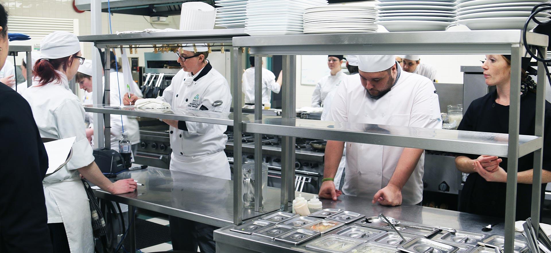 Busy culinary class working on assignments in one of the teaching kitchens.