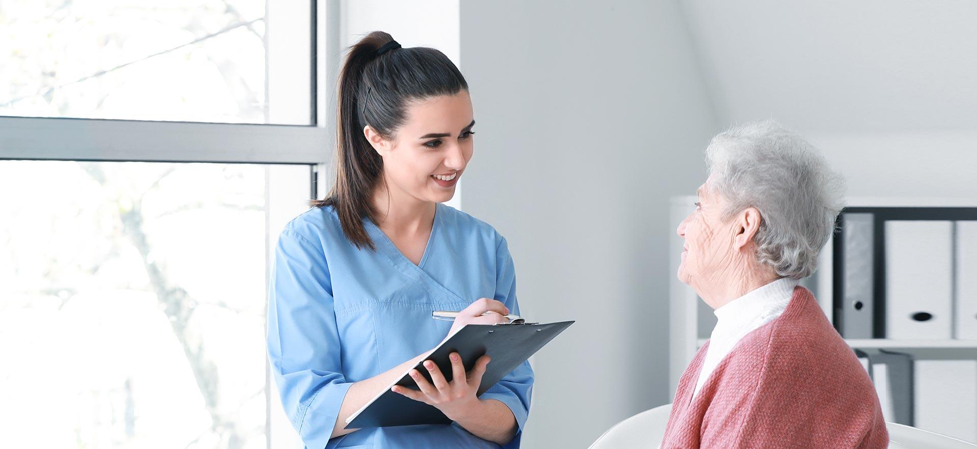 Female nurse questioning a senior in a retirement home.