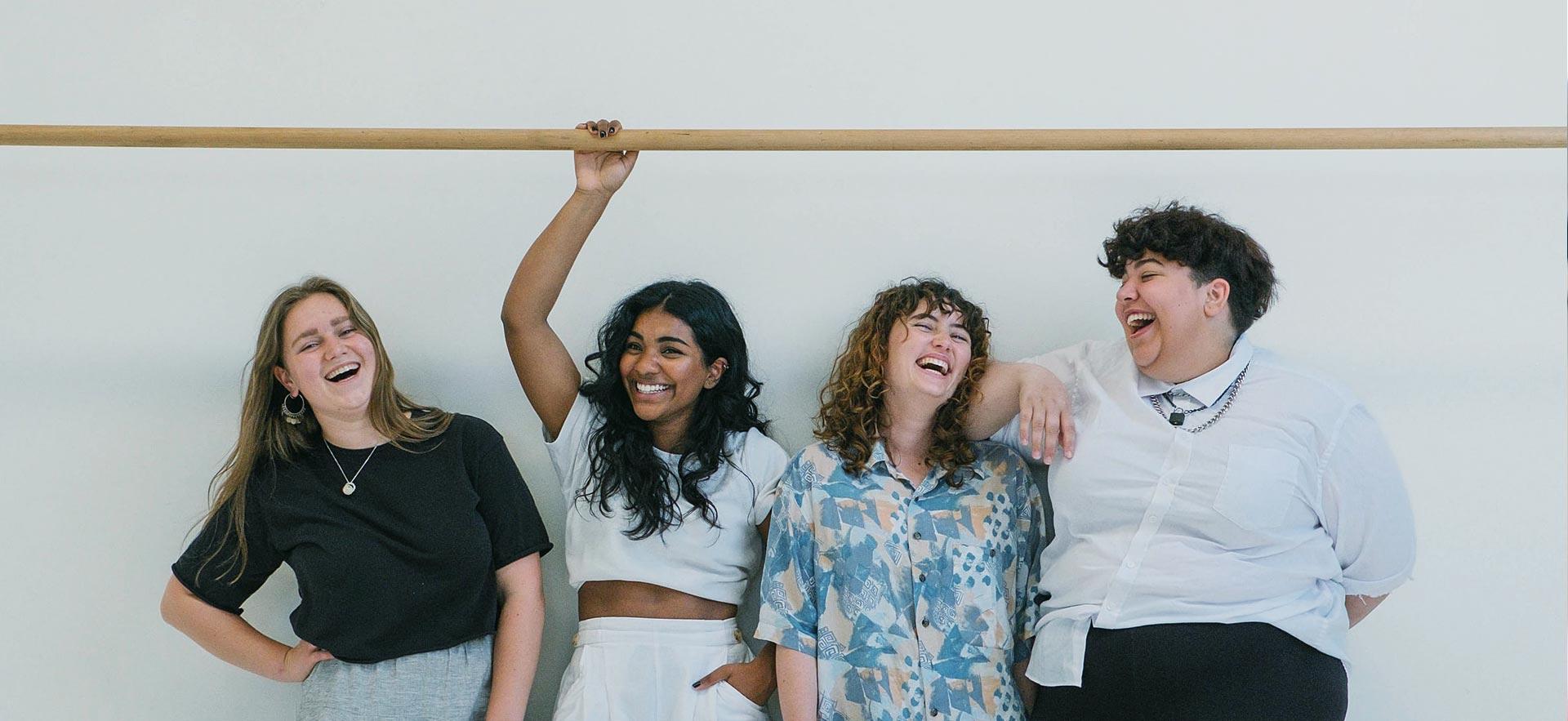 A group of culturally diverse females enjoy laughter.