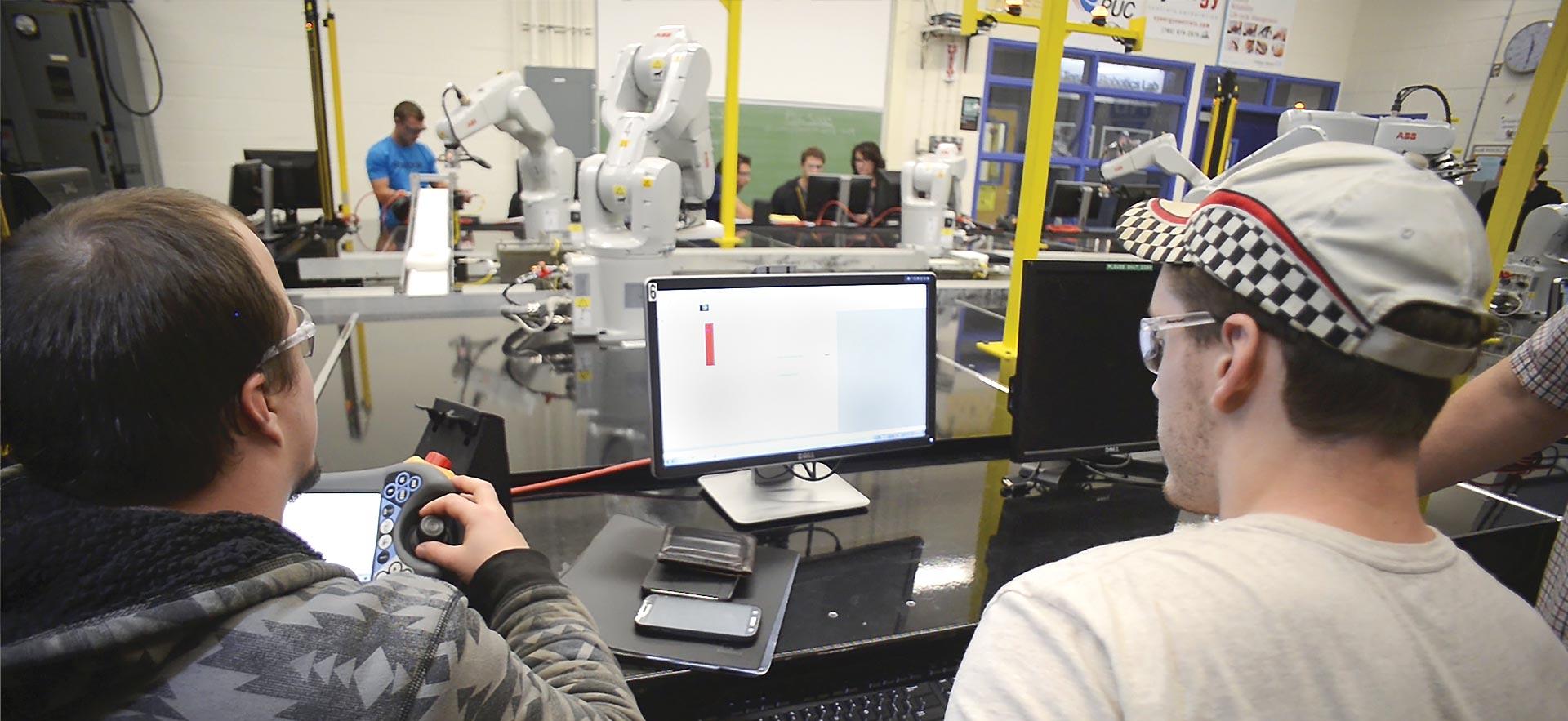 Two male Electrical Engineering student collaborating on an automated project.