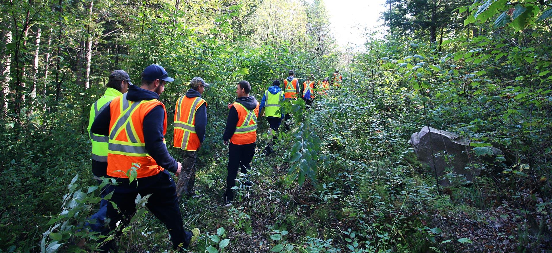 A group of forestry conservation students head out on a hike.