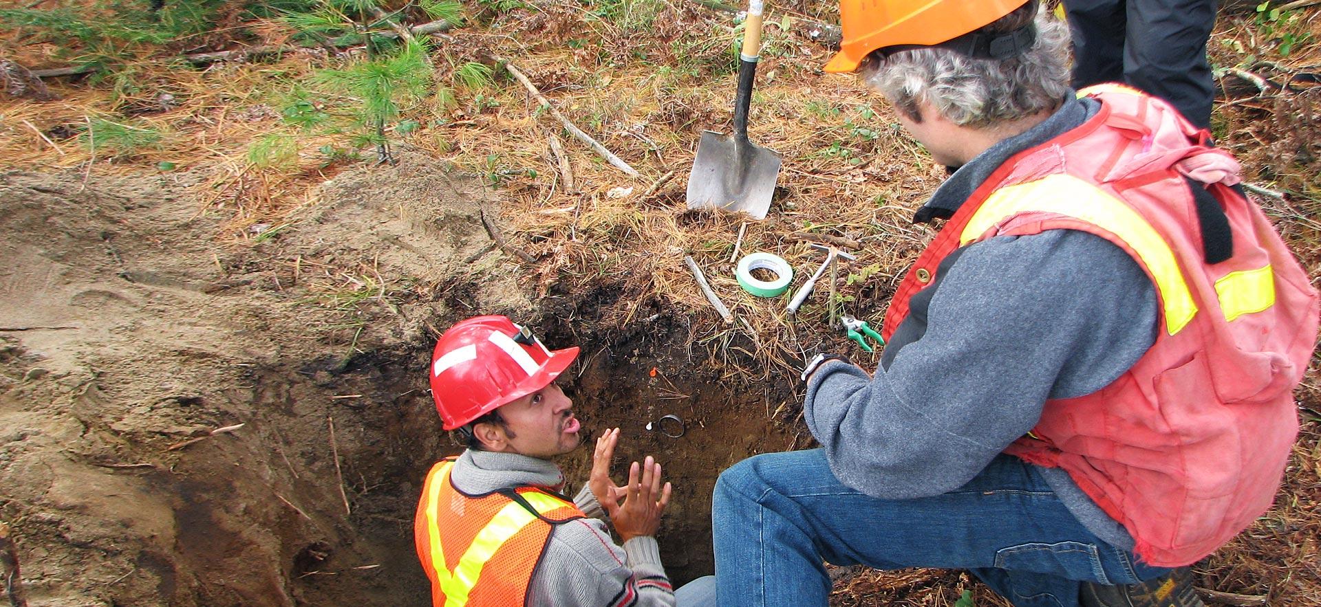 Male forestry conservation technician student talks to his instructor about soil.