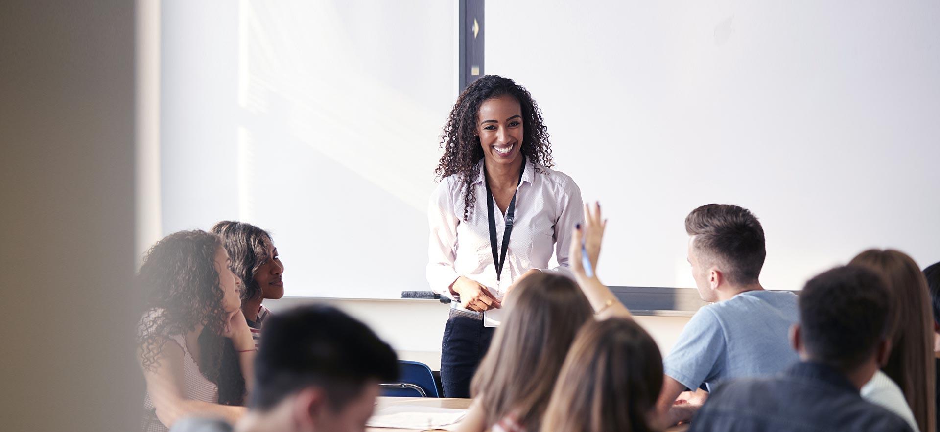 Female teacher taking questions during class.