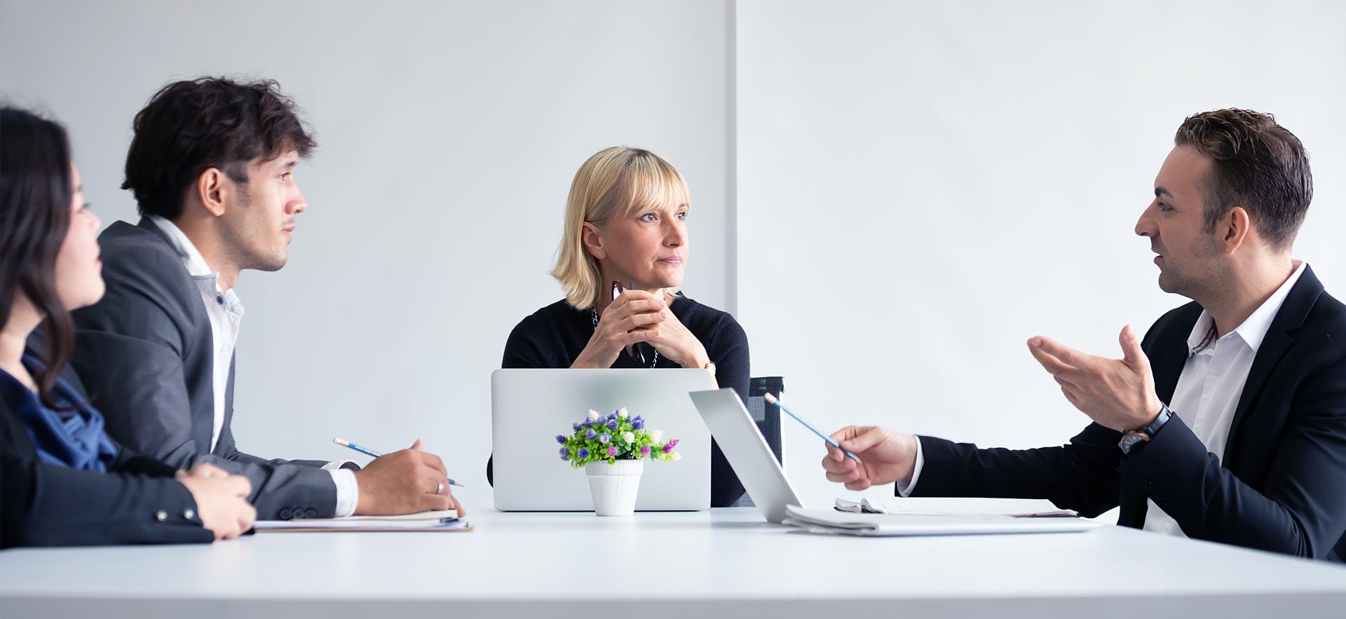A female language interpreter helps facilitate a meeting.