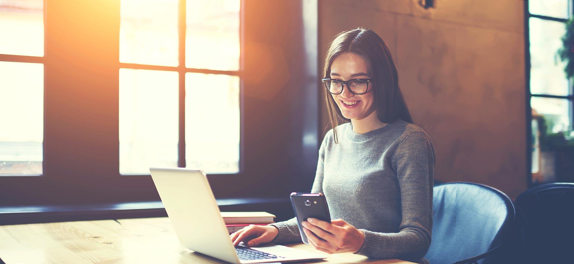 Woman smiling while she works on her computer.