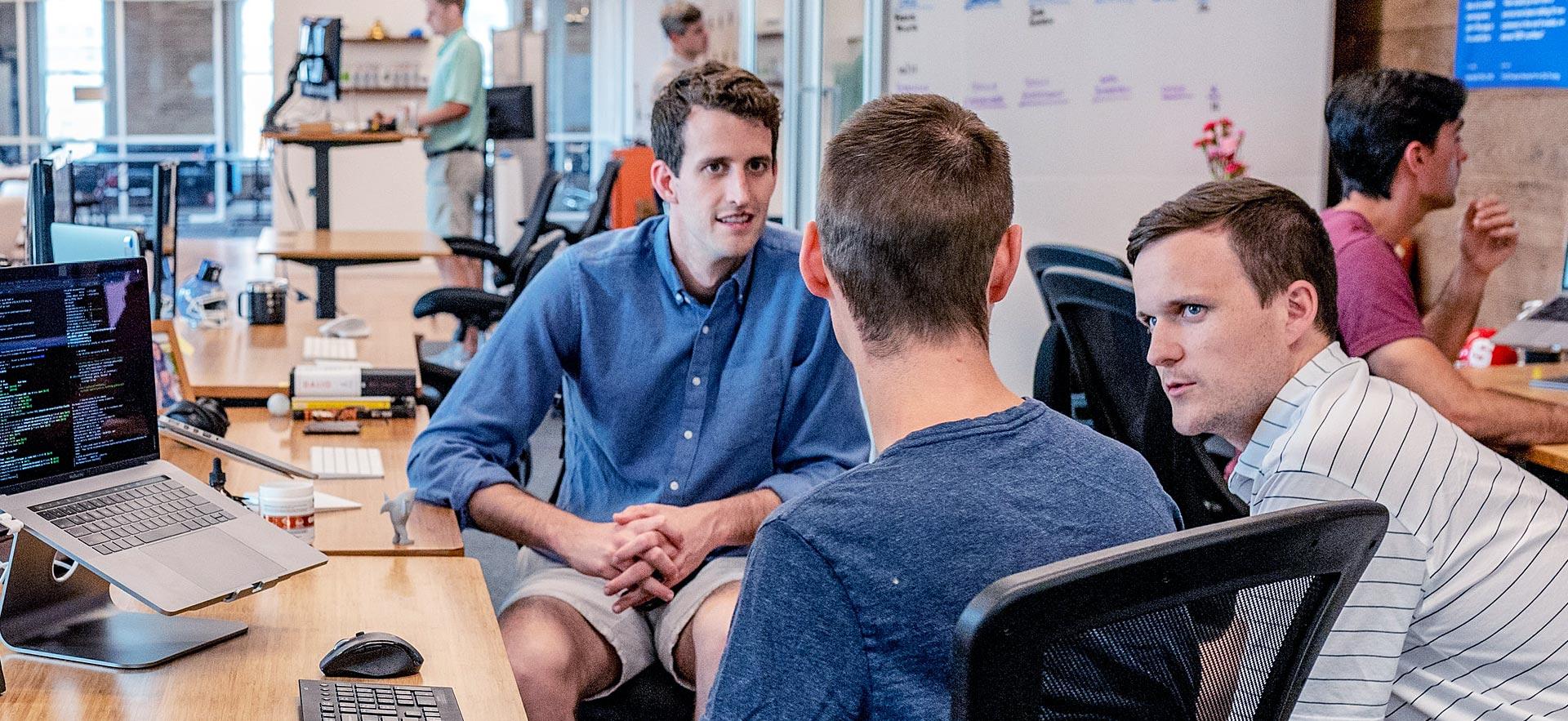 Three males meet for a Social Entrepreneurship meeting.