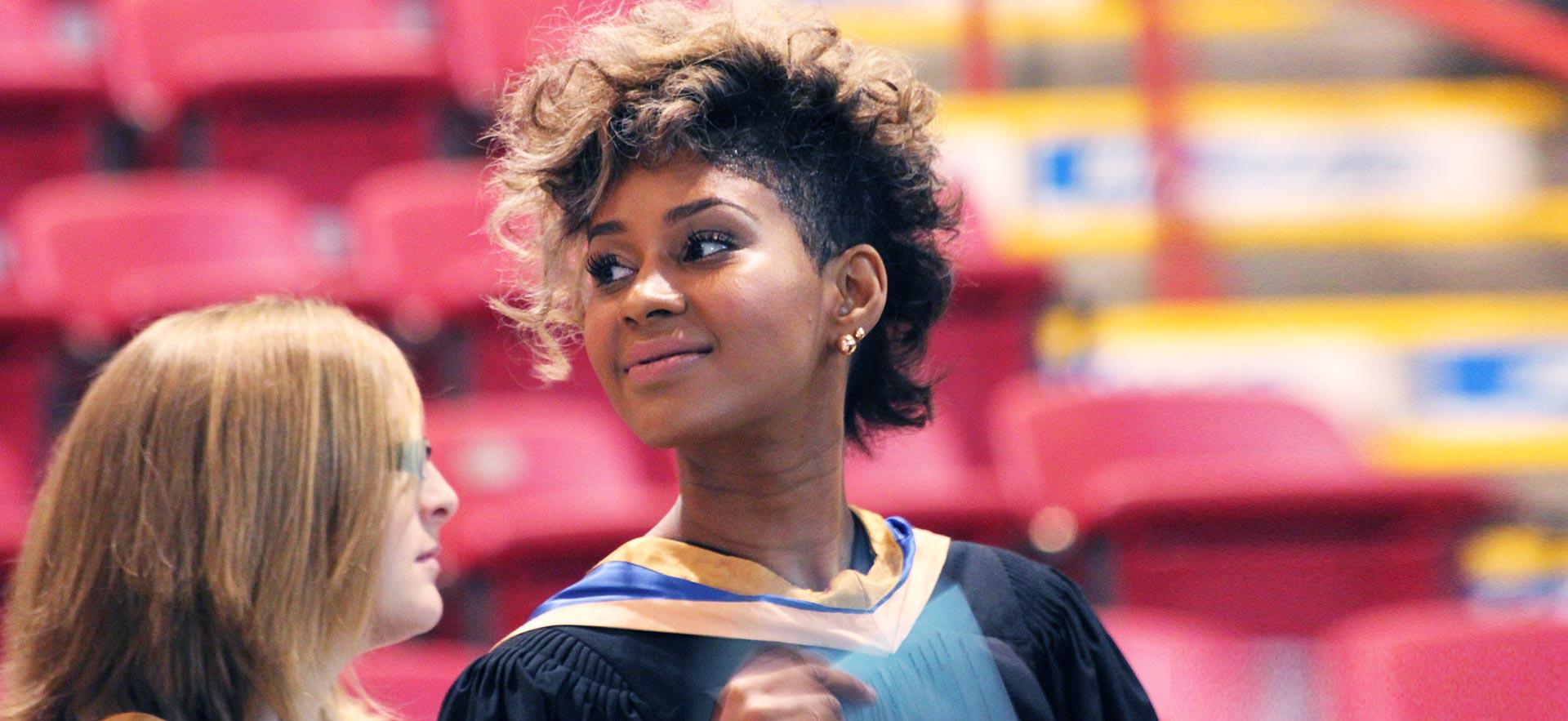 Two female Sault College graduates.