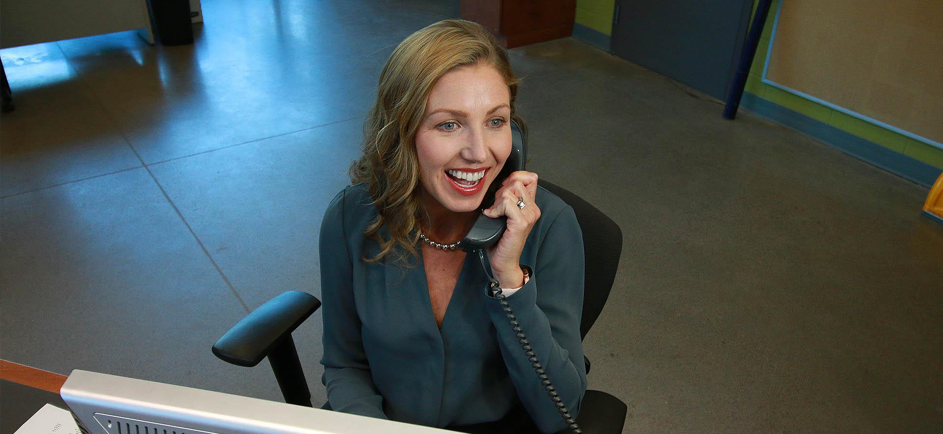 Financial Aid representative holding phone