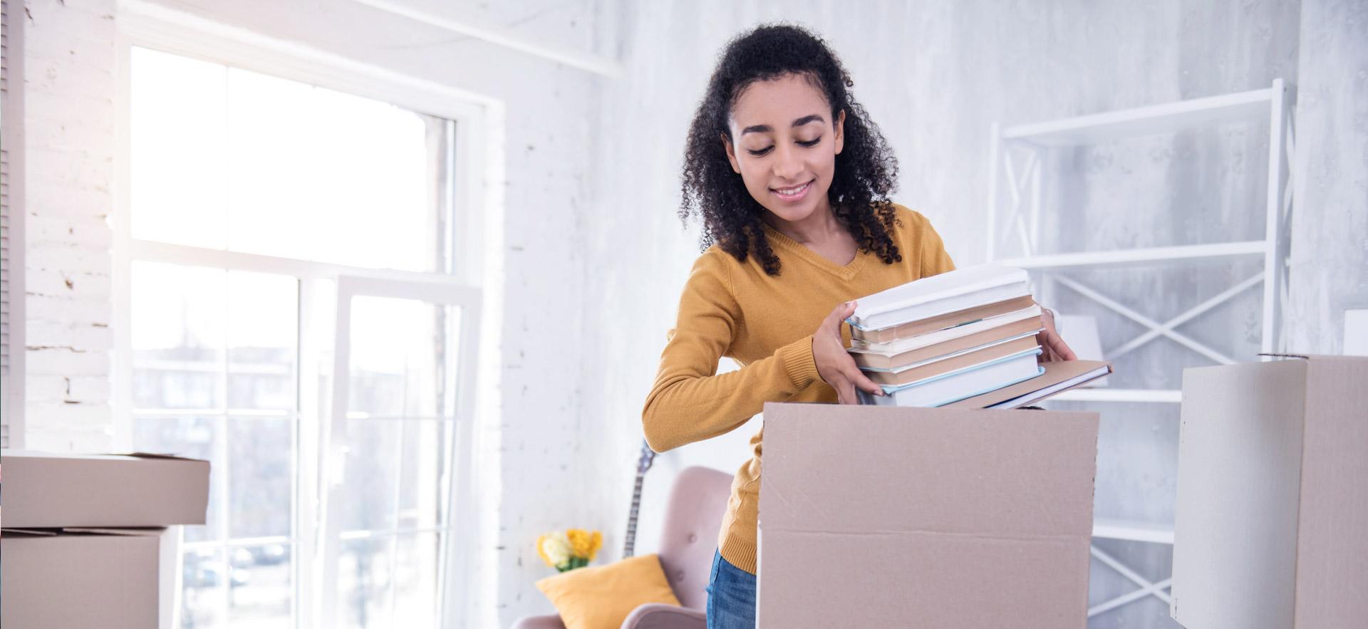 Young female student moving in.