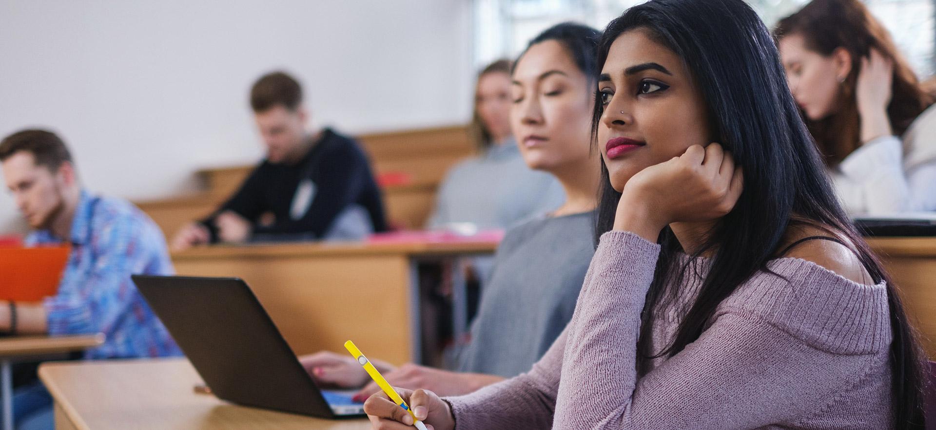 Female student listening in class.