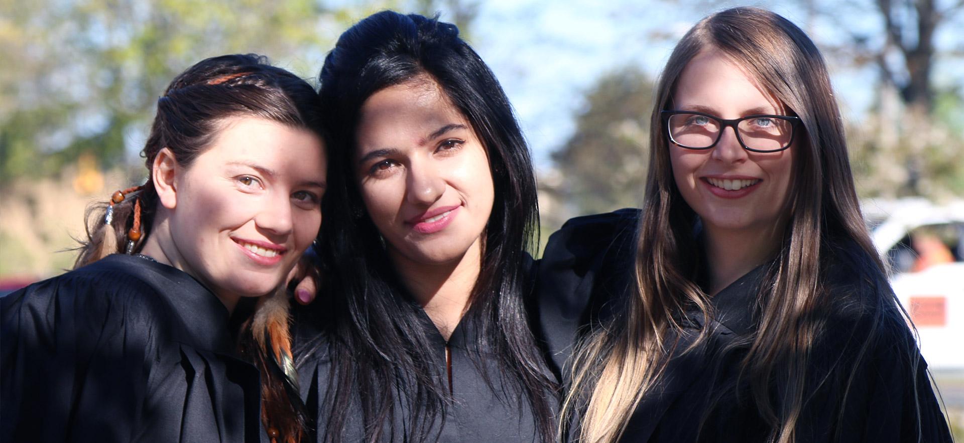 Three female Sault College graduates.
