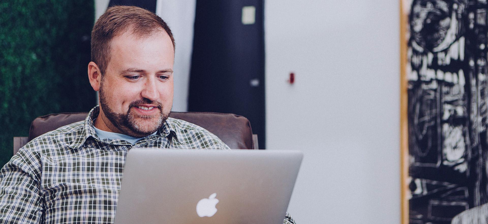 Male adult on a computer.