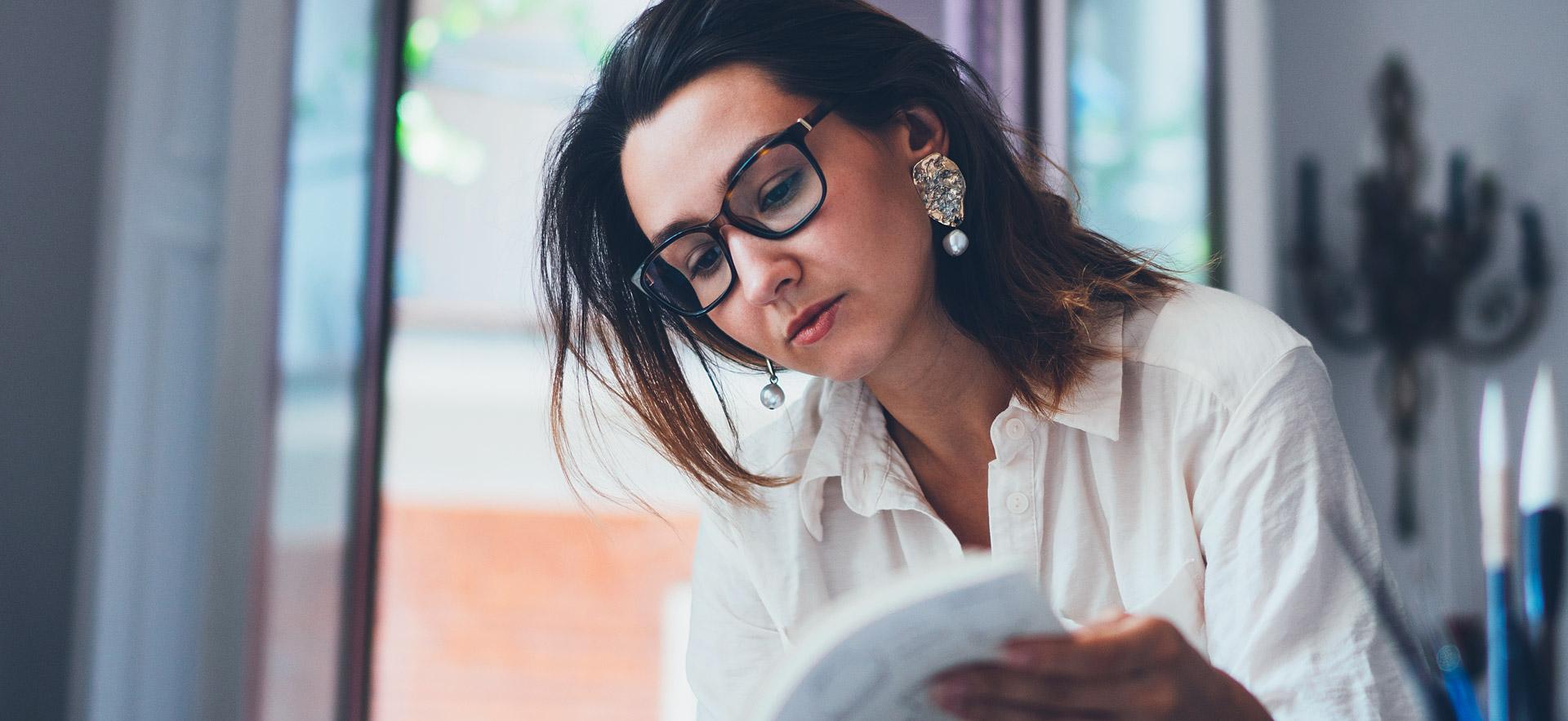 Female student looking through a book.