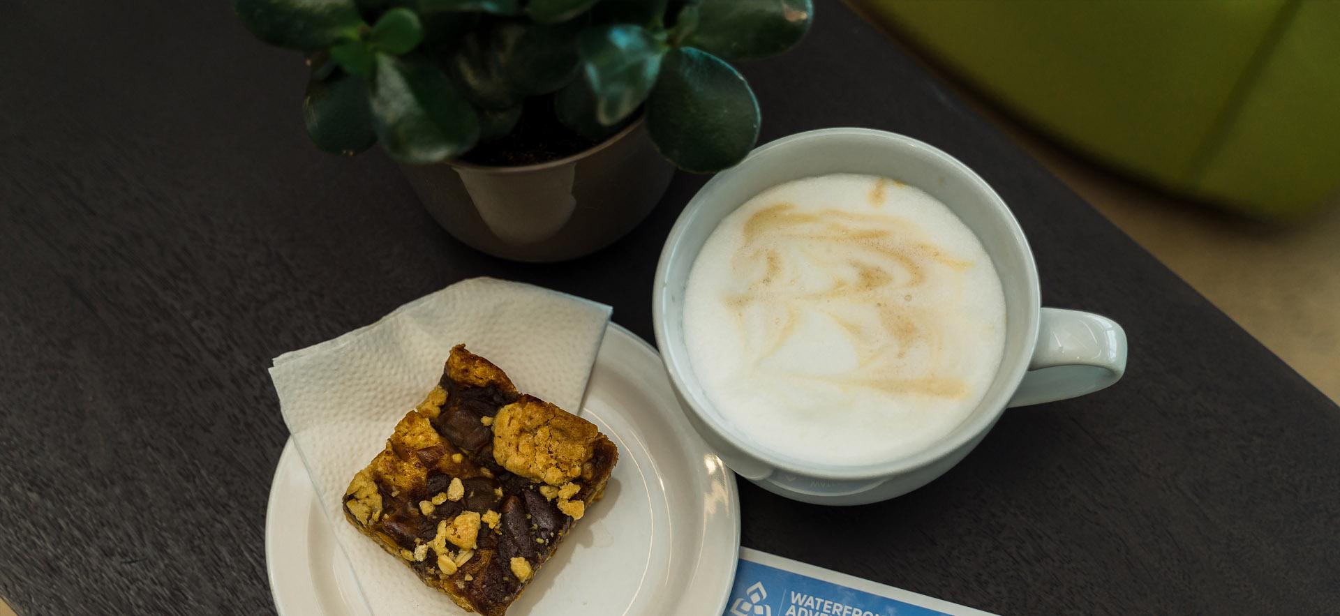 Coffee and treat on table inside waterfront centre