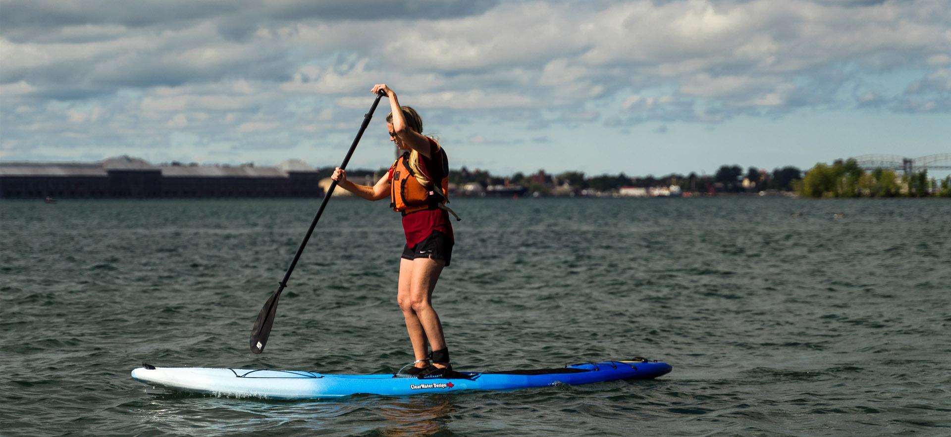 Girl on stand-up paddle-board on river