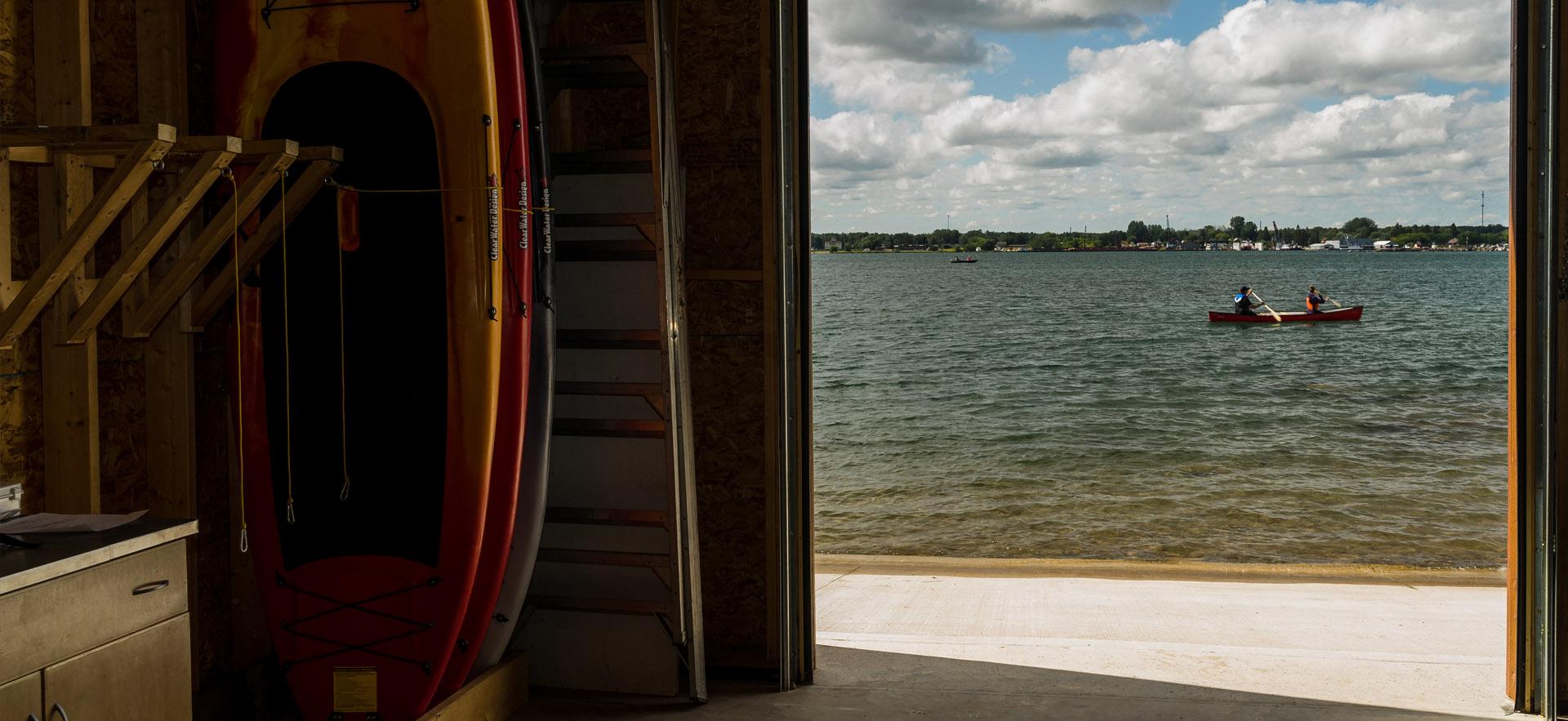 garage door view of kayakers on river
