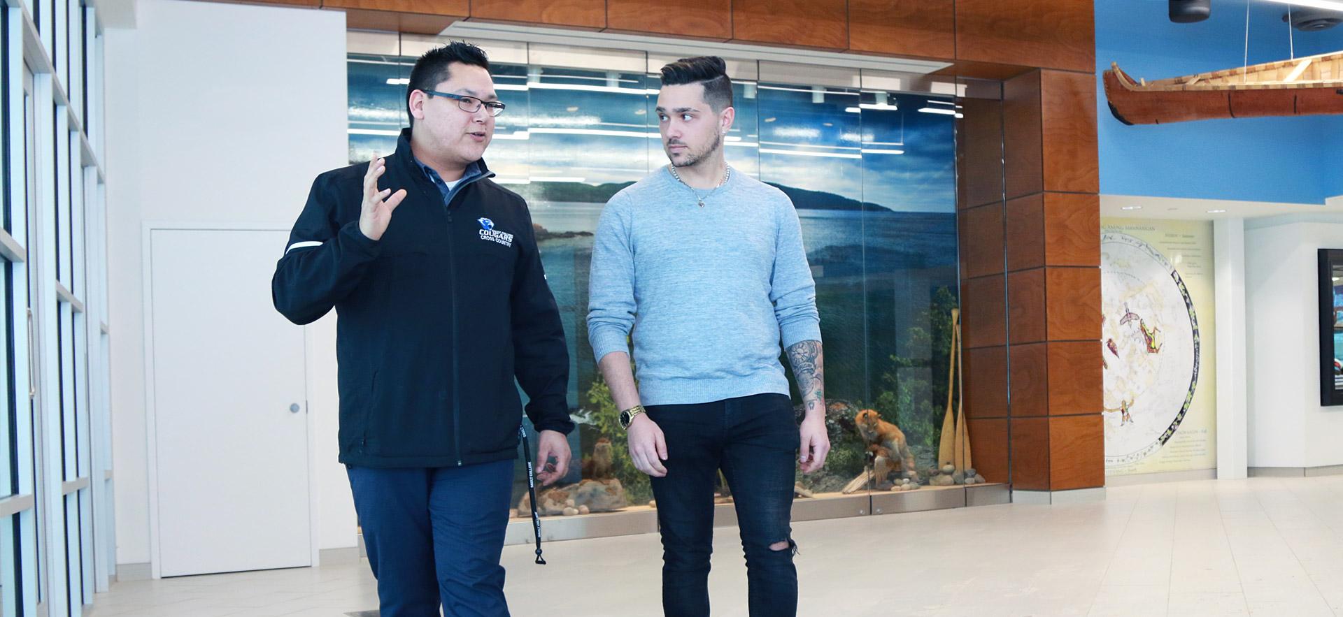 A male student is taken on a tour of Sault College.