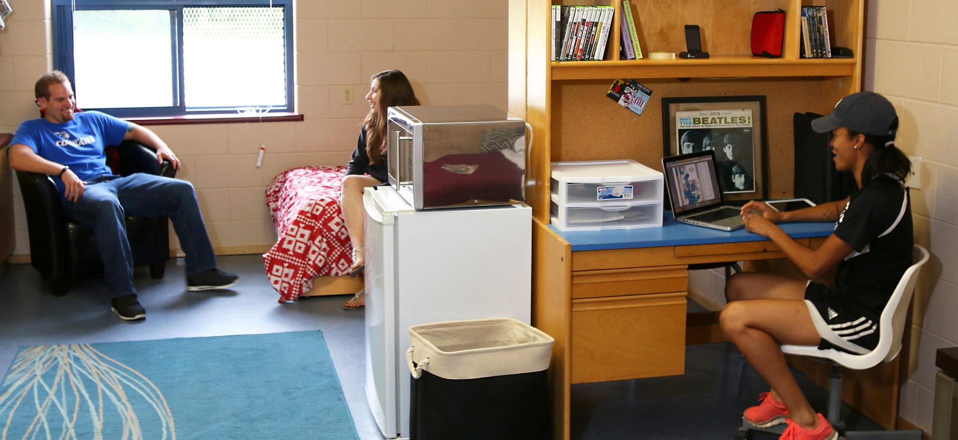 students talking and studying in residence room