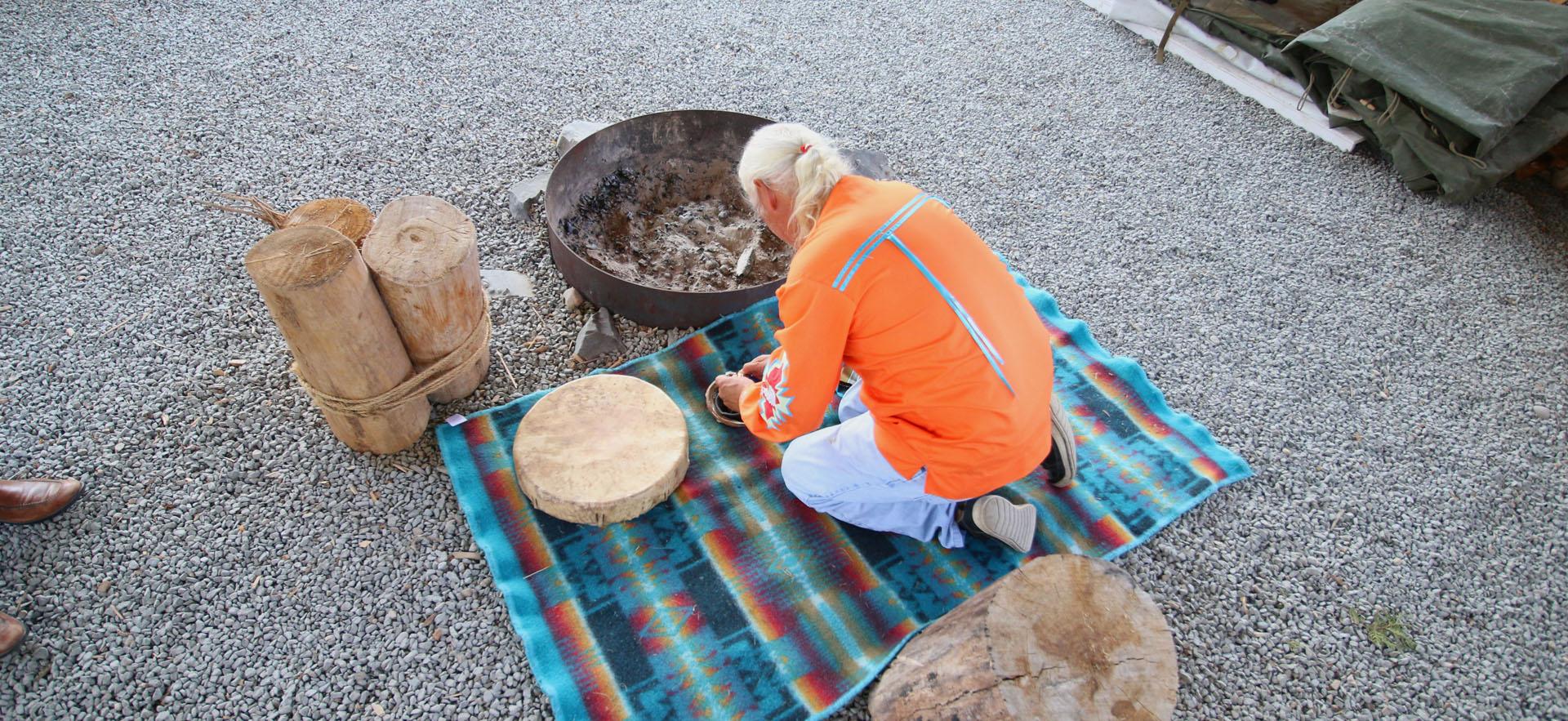 Elder in our sacred fire arbour preparing for ritual