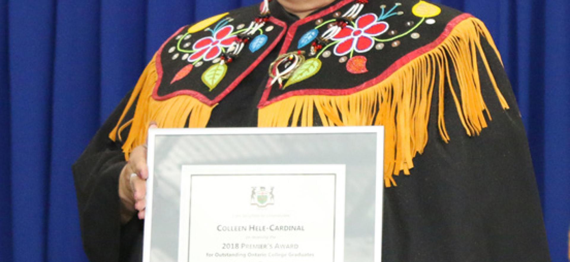 Female graduating student receiving an award.