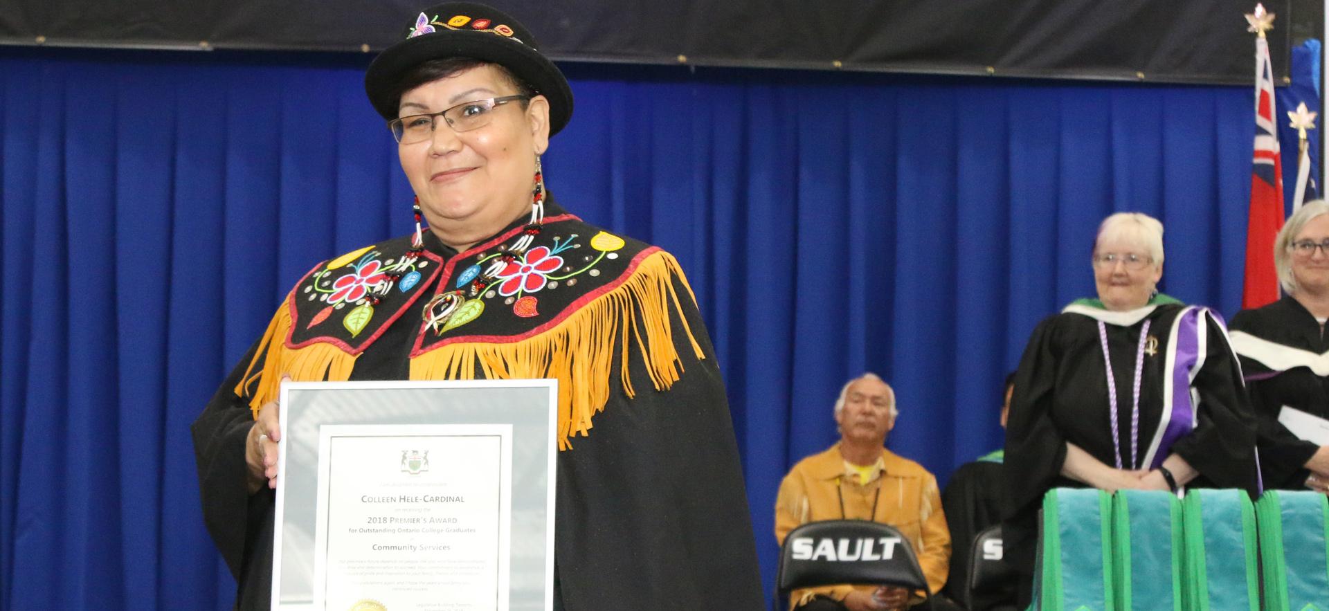 Female graduating student receiving an award.