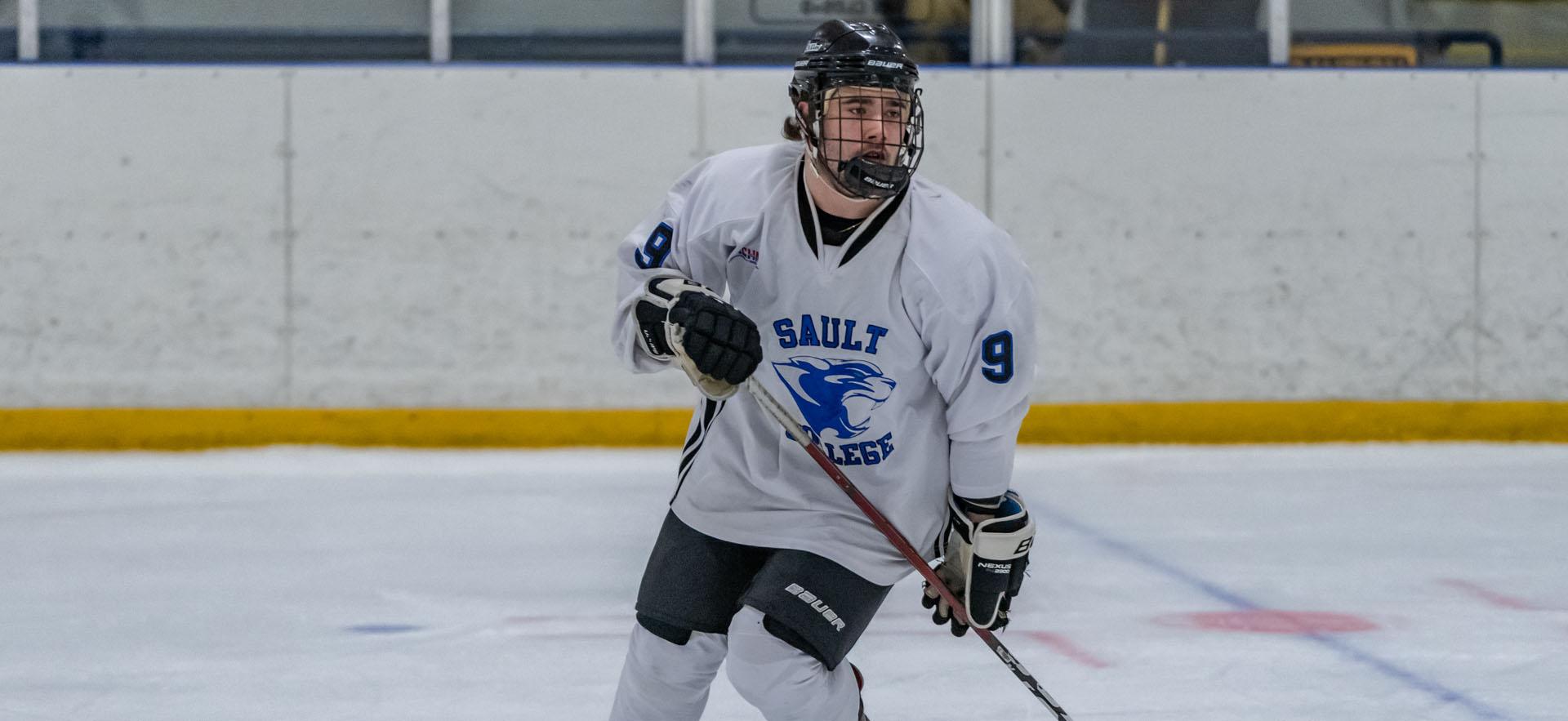 Hockey player skating across the ice