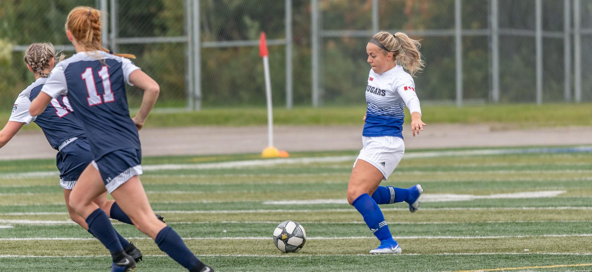 female soccer player with soccer ball 