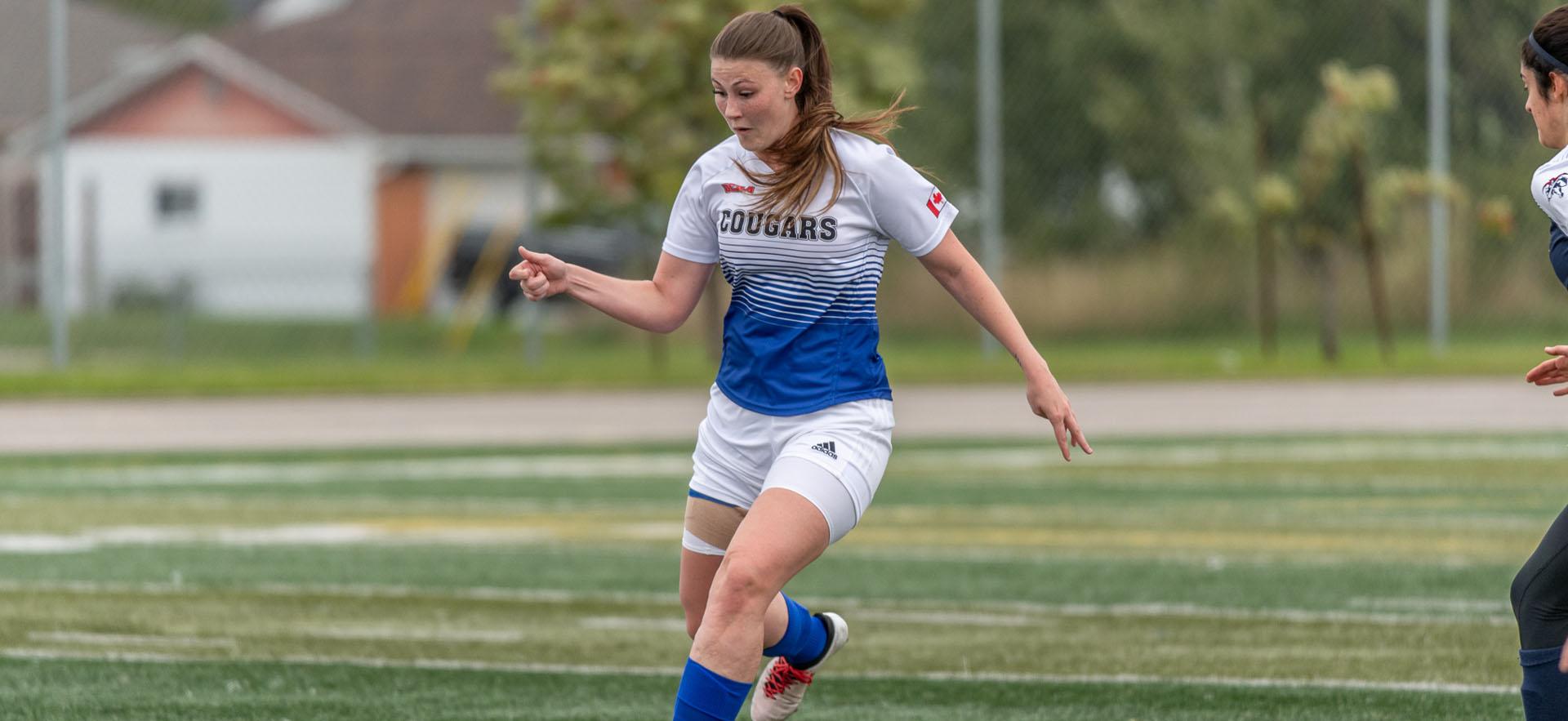 female soccer player with soccer ball 