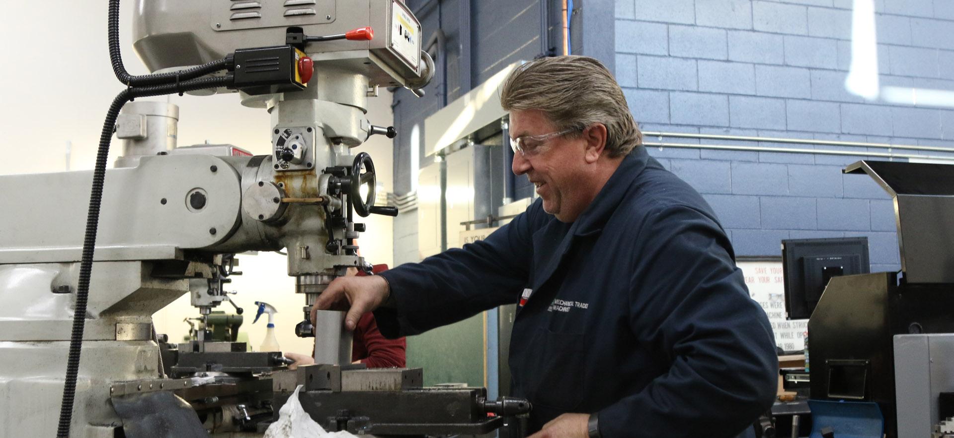 Instructor working at machine 