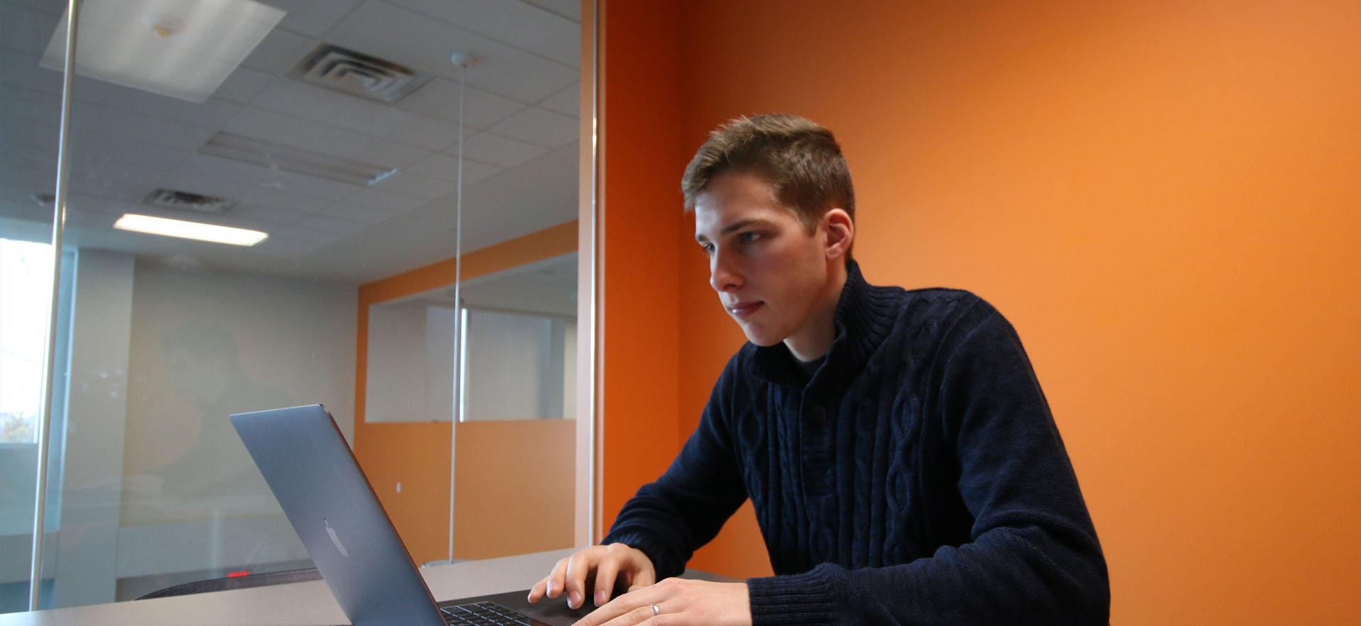 Male. student looking at computer screen