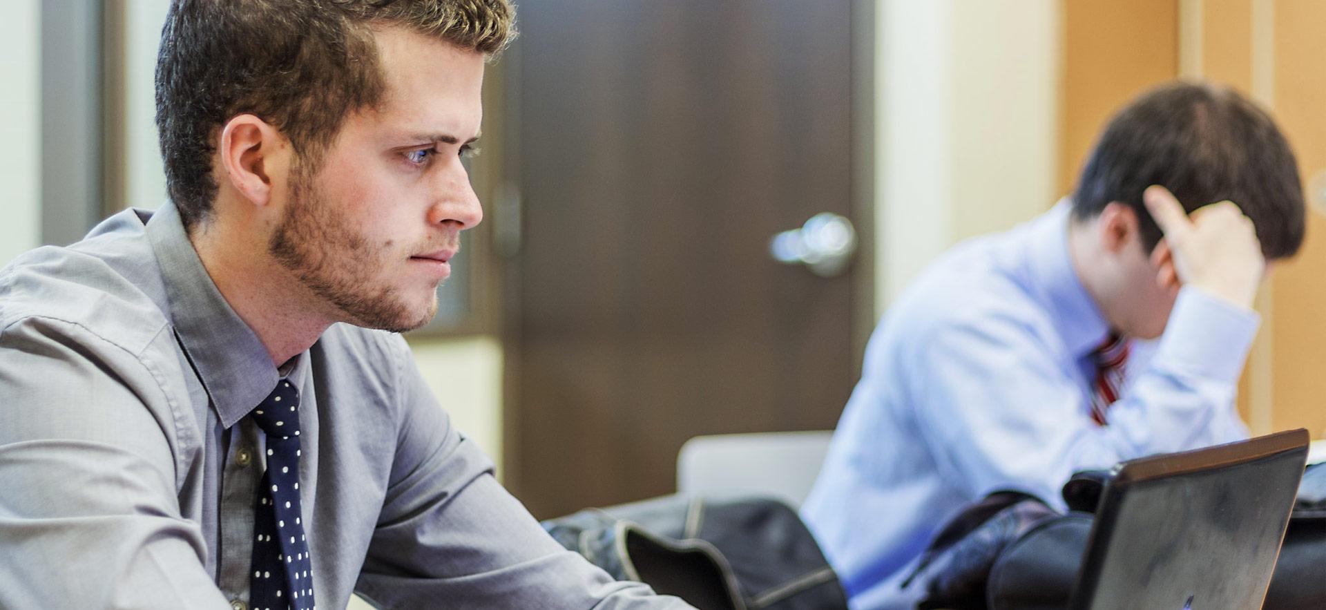 student sitting at workstation with laptop