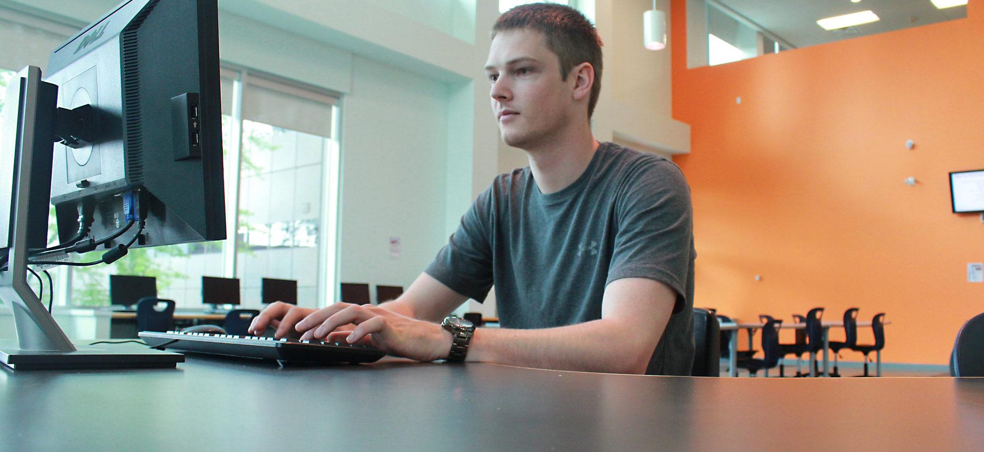 student at computer workstation