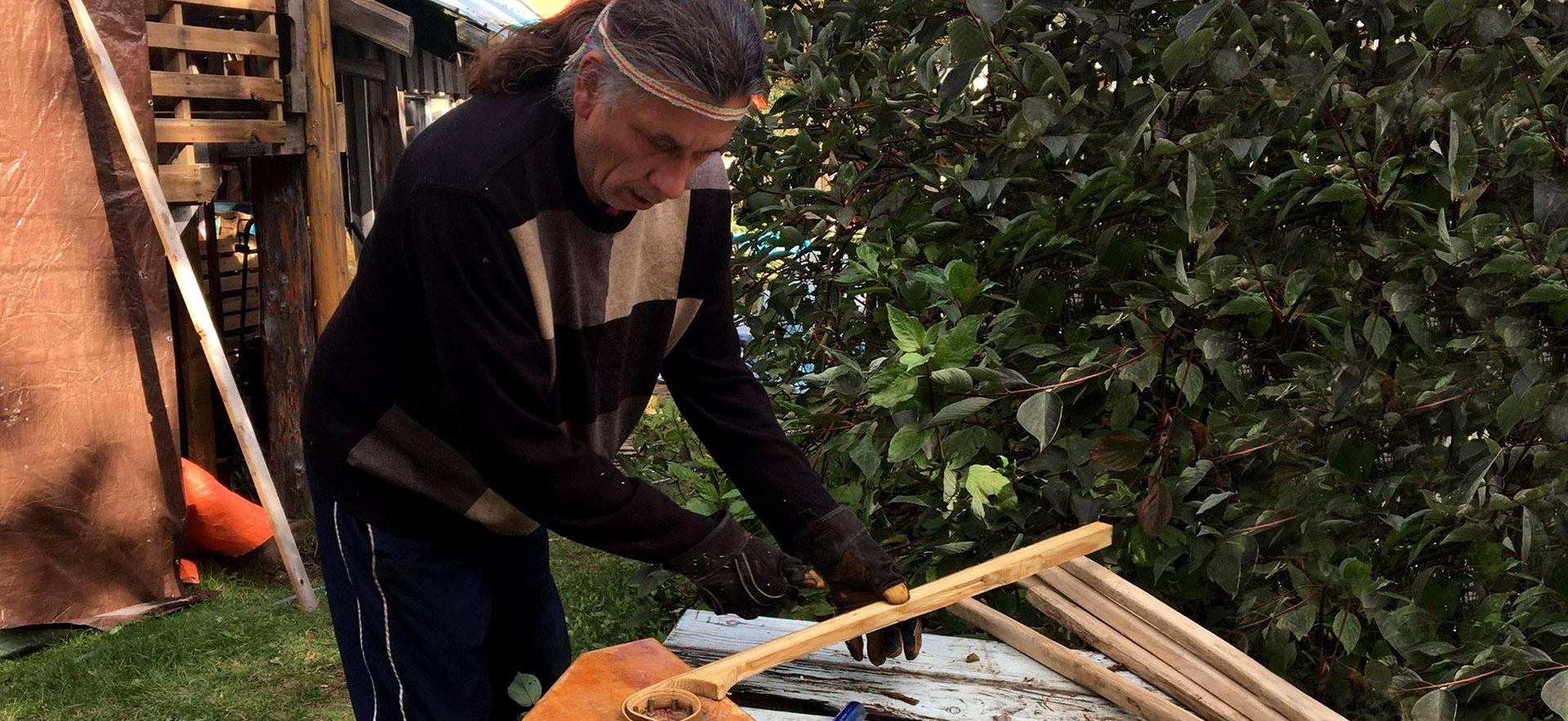 Frank works on constructing the lacrosse sticks