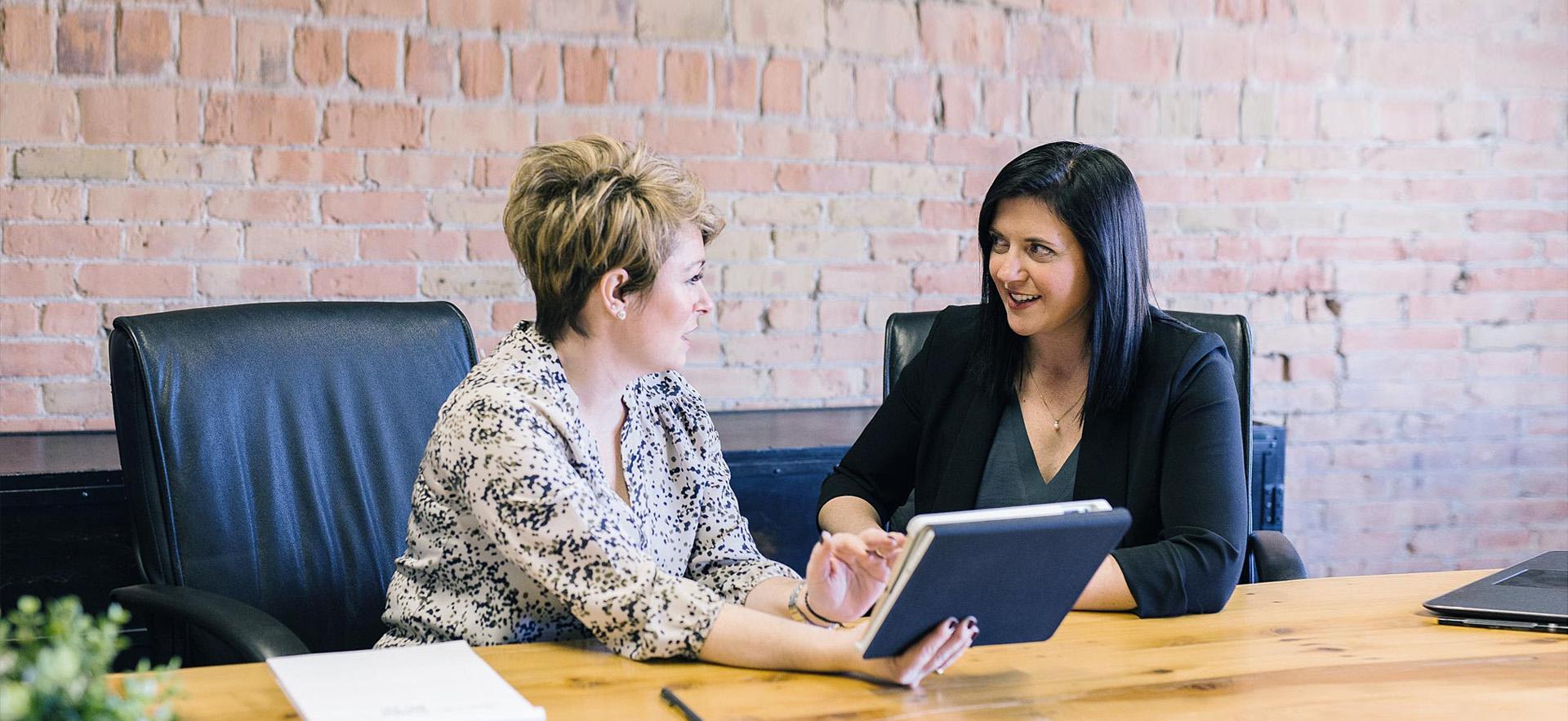 Female Human Resources person working with a new hire.