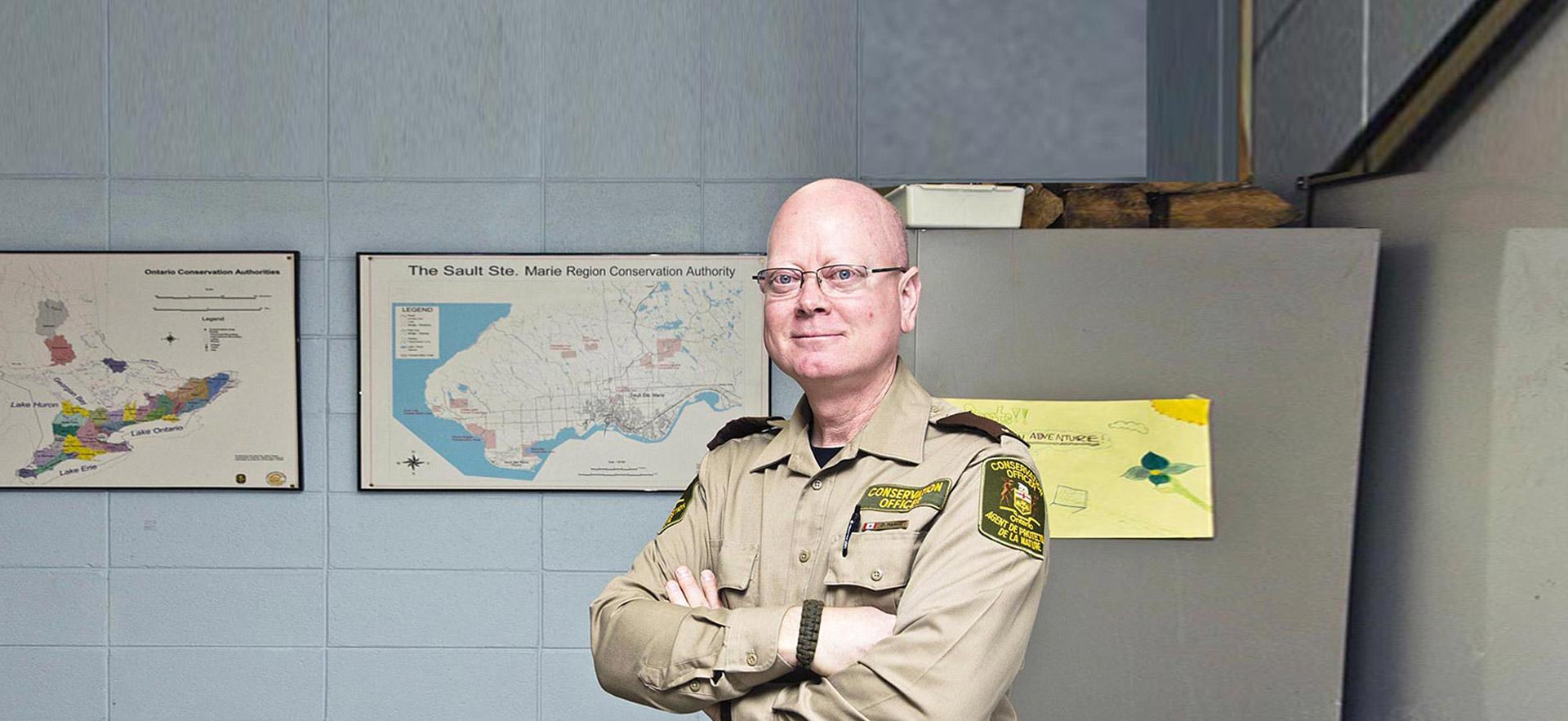 A smiling male Sault College Natural Resource/Environmental Law - Inspection and Enforcement instructor poses for a photo. 