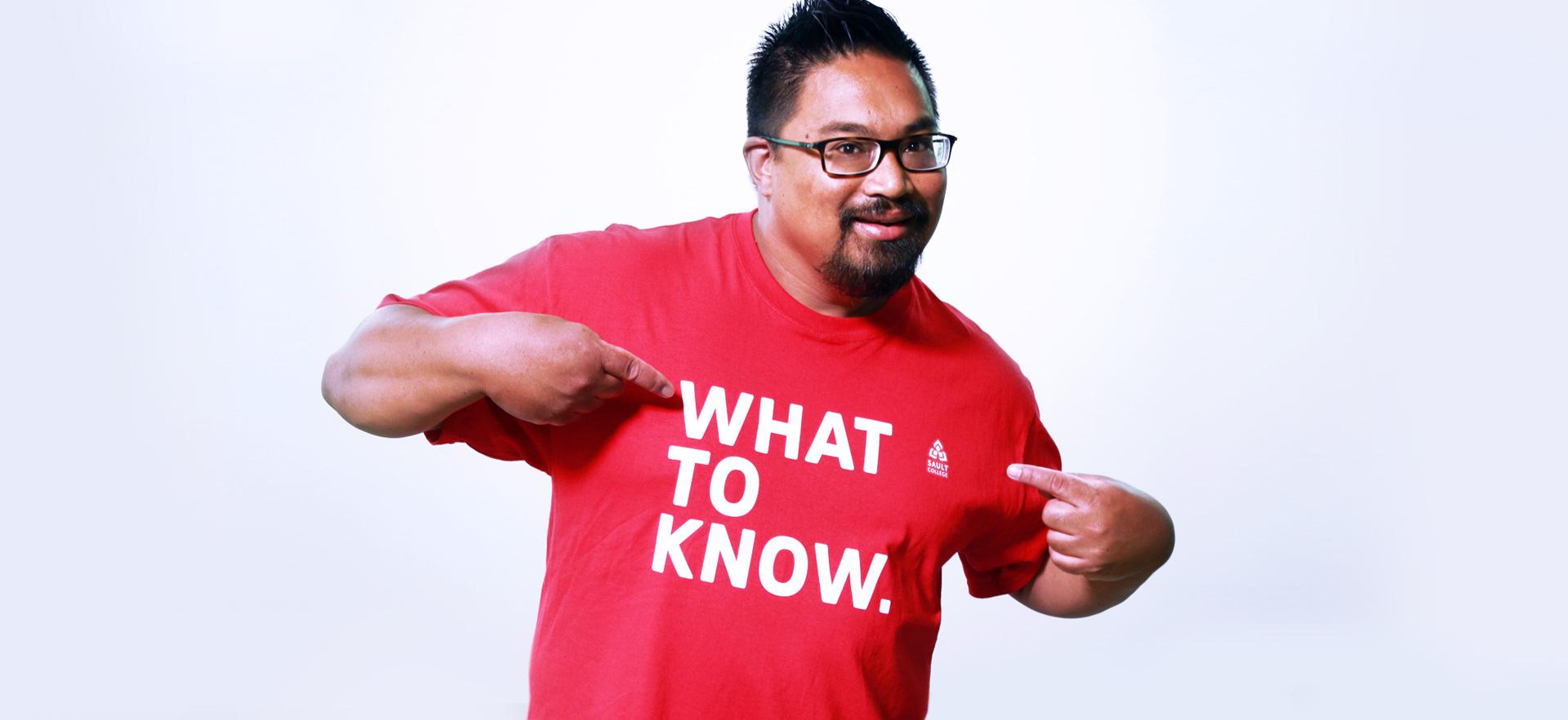 Recruiter pointing to t-shirt saying "What to know"