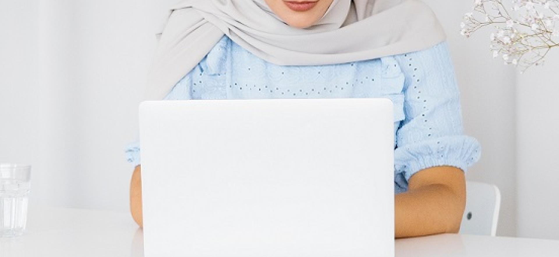 Woman at a desk working on a laptop