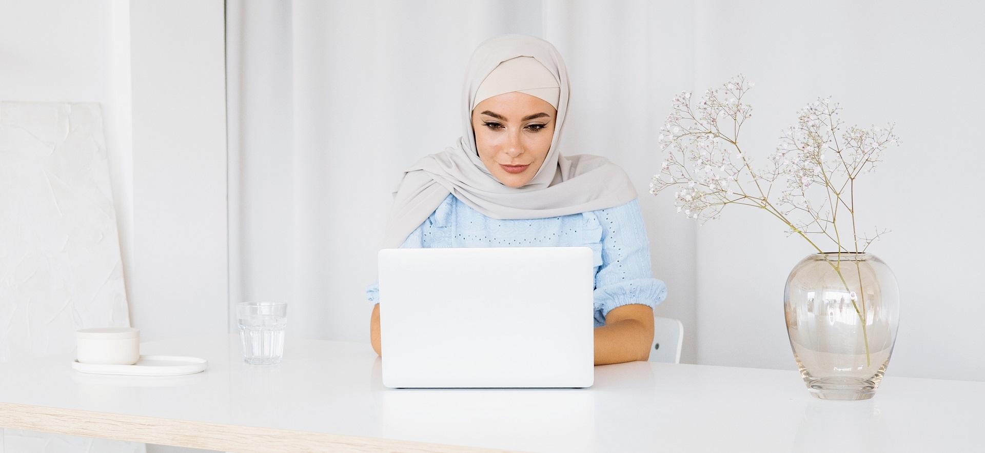 Woman at a desk working on a laptop