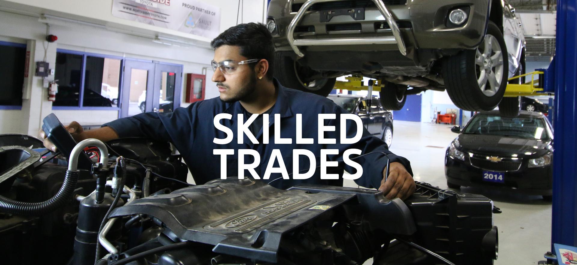 Male motive power student working on car engine.