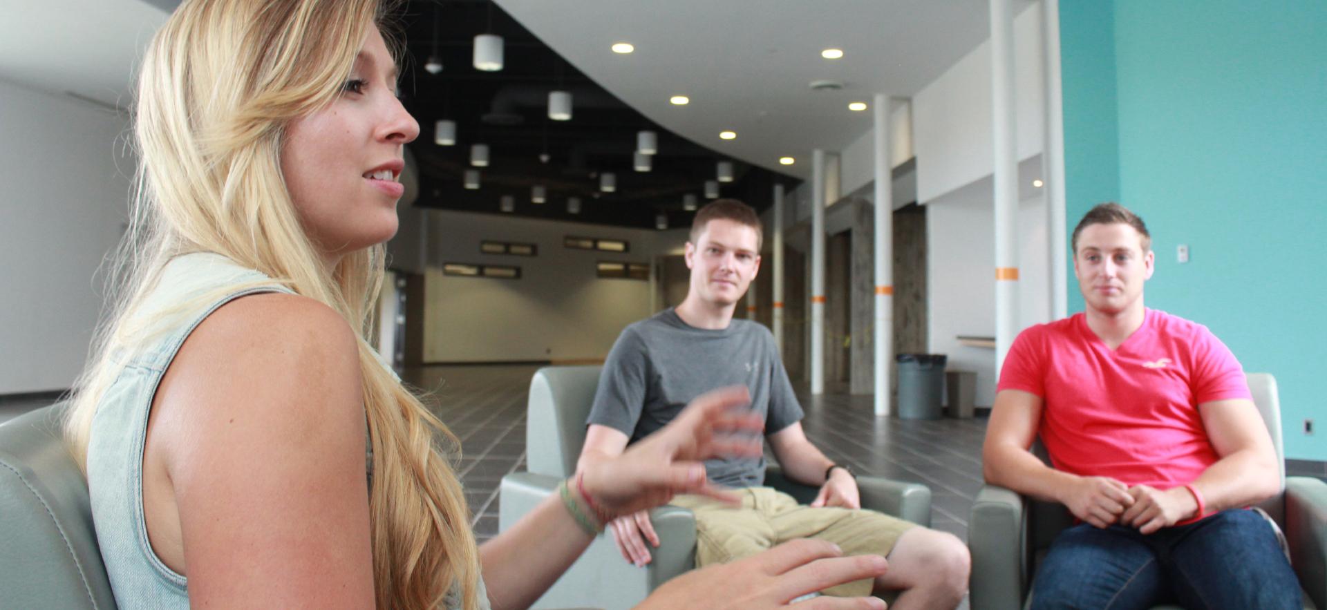 woman sitting with student and talking