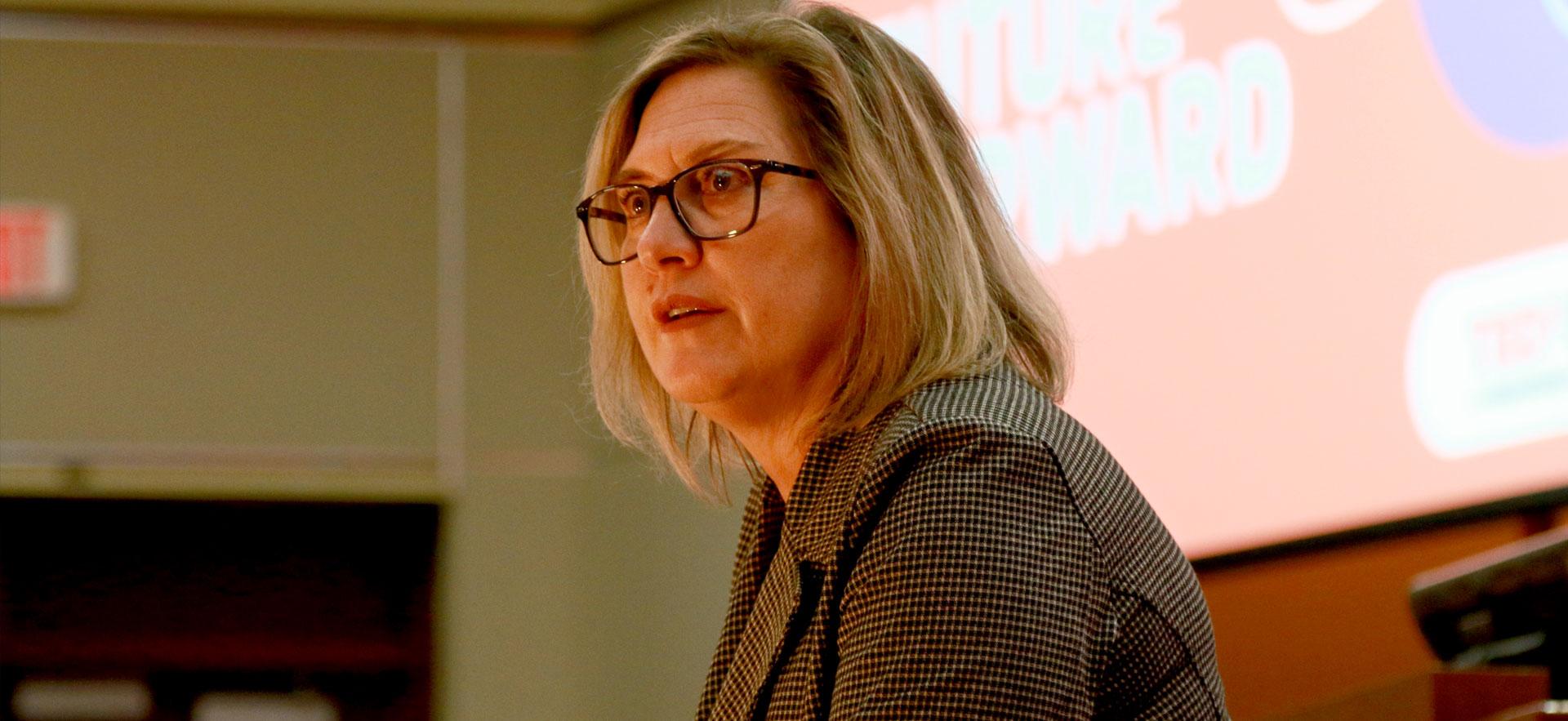 Lady speaking intensely at audience