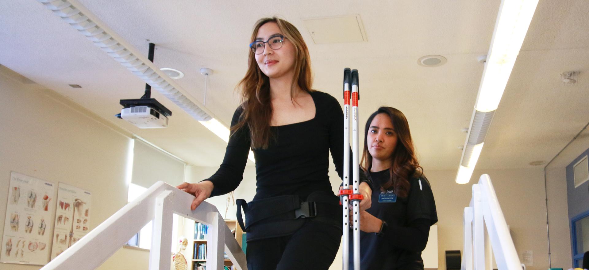 OTA & PTA student teaching a client how to use crutches on the stairs