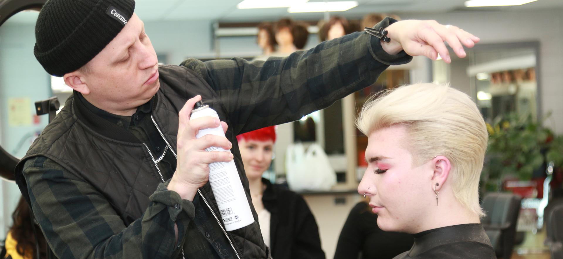 Peter Gosling of Glassbox Education doing a student's hair to teach short hairstyle techniques in his workshop