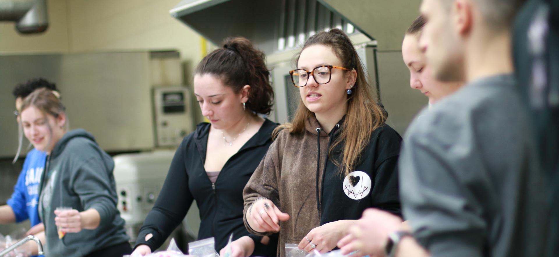 Business students sorting items to manufacture their product for an entrepreneurship course