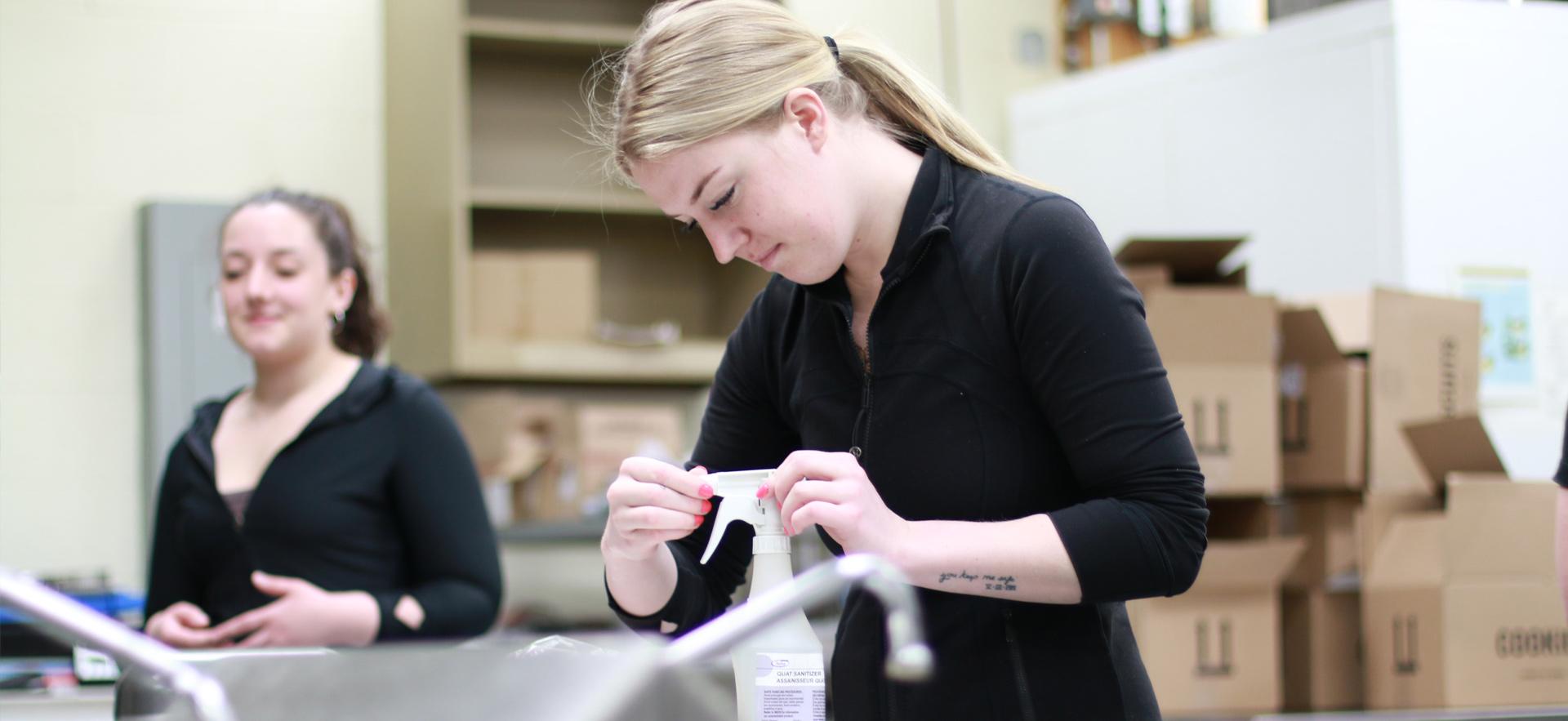 Business student prepping a station to manufacture product with safe handling procedures