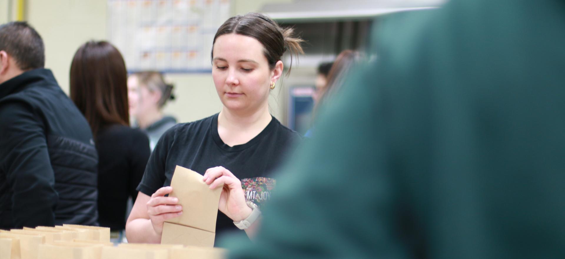 Business student preparing bags to manufacture their product for an entrepreneurship course