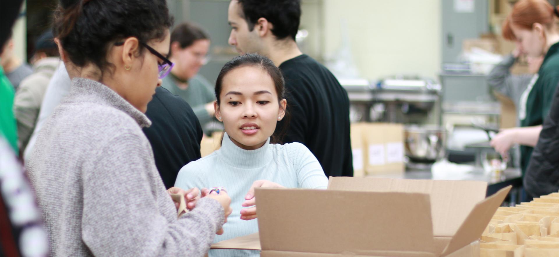 Business students sorting items to manufacture their product for an entrepreneurship course