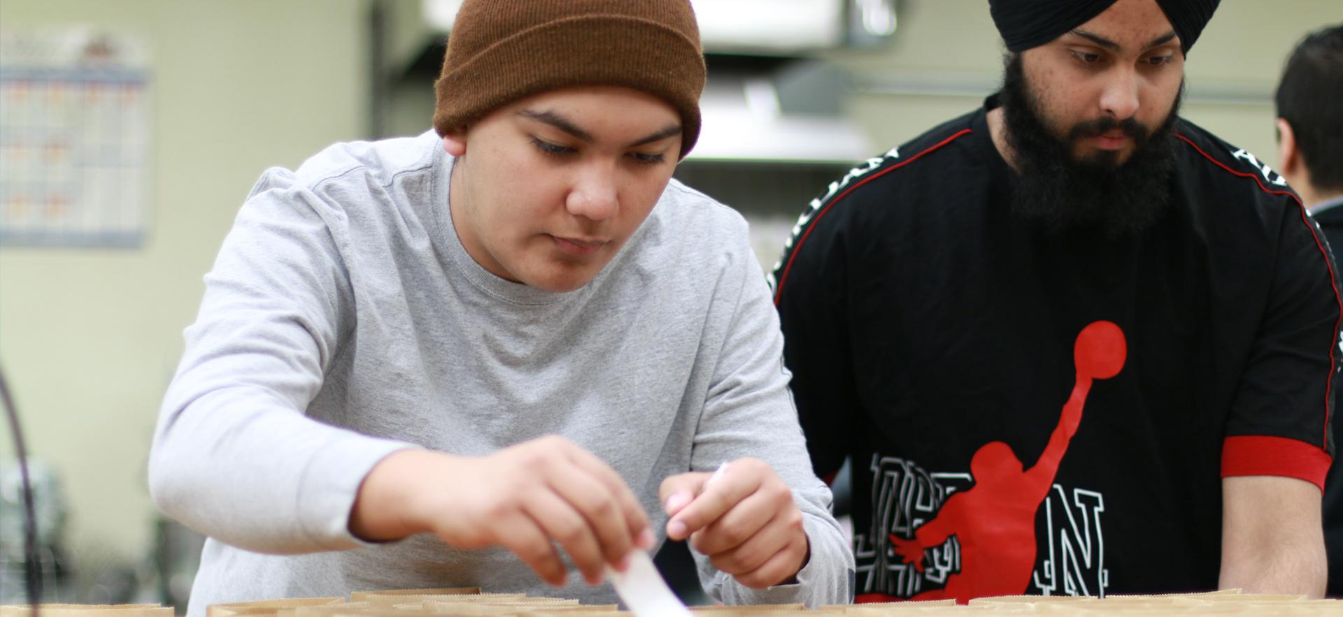 Business students sorting items to manufacture their product for an entrepreneurship course