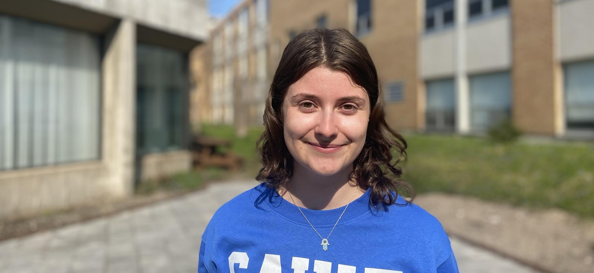 photo of Raquel student ambassador for School of Natural Environment smiling for camera sitting outside on campus