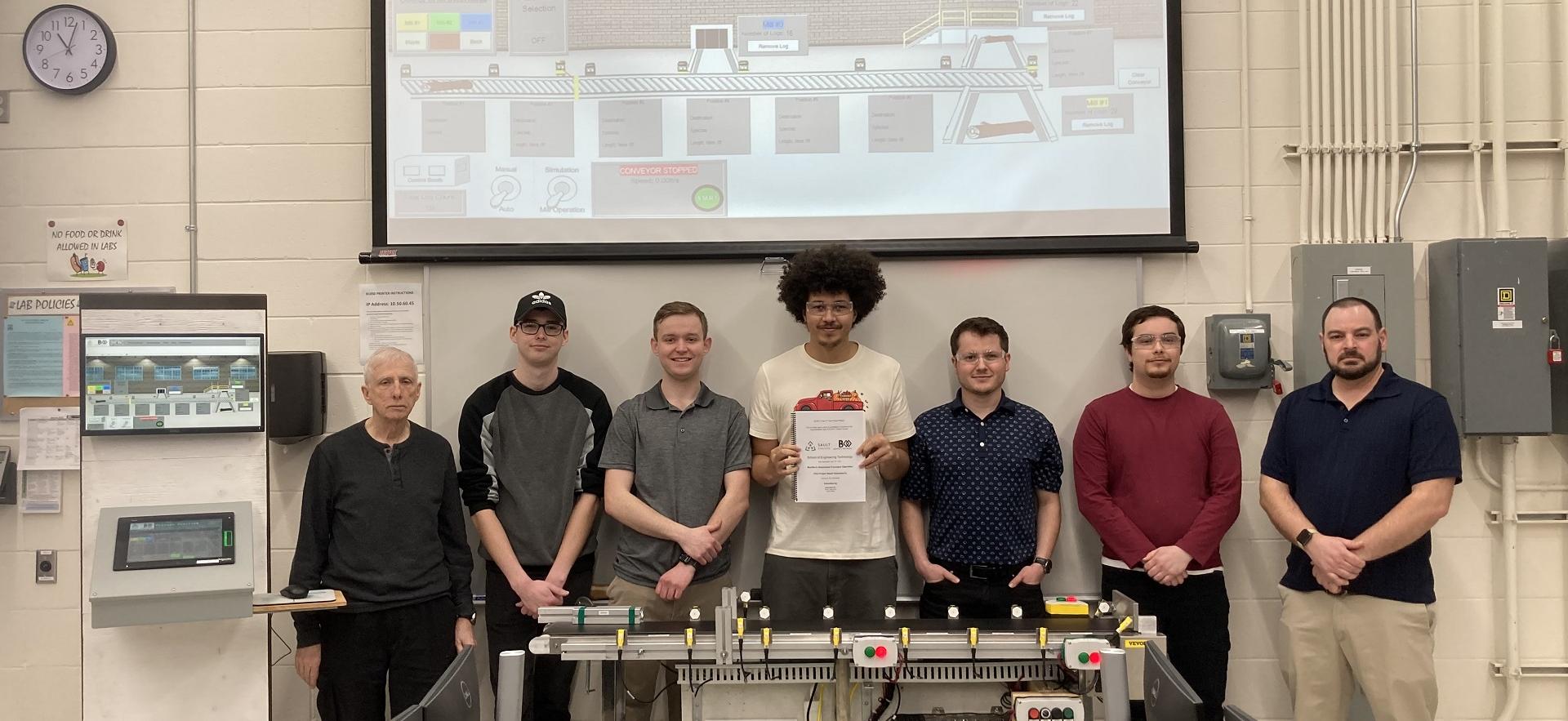 Engineering students and instructors posed with their demonstration